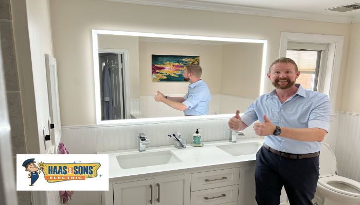 Haas Company Photo Man In Bathroom Giving Thumbsup In Front Of Mirror With Backlighti electrical installations near me Pasadena