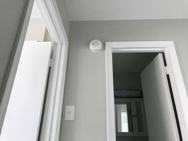 Haas & Sons electrician installing a hardwired smoke detector in a Maryland home